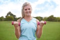 Woman, portrait and dumbbells outdoor for exercise with smile for workout, training or fitness on sports field. Athlete Royalty Free Stock Photo