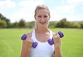 Woman, portrait and dumbbells outdoor for workout with smile for exercise, training or fitness on sports field. Athlete Royalty Free Stock Photo