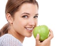 Woman, portrait and eating apple, nutrition and gut health with snack or meal, diet for weight loss on white background