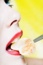 Woman Portrait eating a tangerine slice Royalty Free Stock Photo