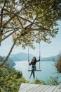 woman portrait enjoying nature from a hill top sitting on a swin Royalty Free Stock Photo