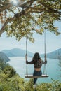 woman portrait enjoying nature from a hill top sitting on a swin Royalty Free Stock Photo