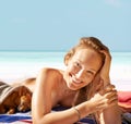 Woman, portrait and happy on beach and sunbathing with dog, vacation and travel to Hawaii. Female person, resting and Royalty Free Stock Photo