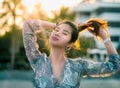 Woman with hard sunflare on with Beach Resort on the background for Summer Beach relaxation concept