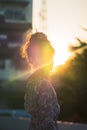 Woman portrait with sunflare on with Beach Resort on the background for Summer Vacation beauty fashion concept