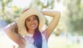 Woman, portrait and hat for relaxing in park or garden, smiling and joyful on summer holiday. Female person, peace and Royalty Free Stock Photo