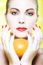 Woman portrait holding a orange citrus fruit