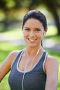 Woman, portrait and listening to music in closeup in park, fitness and commitment to training for healthy body. Young Royalty Free Stock Photo