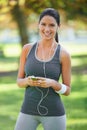 Woman, portrait and listening to music for exercise in park, fitness and commitment to training for healthy body. Young Royalty Free Stock Photo