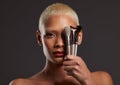 Woman, portrait and makeup brushes for facial beauty cosmetics, skincare or treatment against a gray studio background