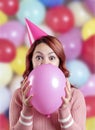 Woman portrait at a party playing with a balloon Royalty Free Stock Photo