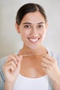 Woman, portrait and smile with dental floss in home for health, wellness or care for teeth in morning. Girl, person and Royalty Free Stock Photo