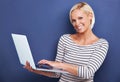 Woman, portrait and smile with laptop in studio for internet connectivity for online email, networking or blue