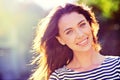 Woman, portrait and smile with nature, sunrise and park for happiness and wellness. Person, joy and bokeh with closeup