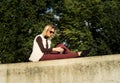 Woman portrait in summer. Girl is sitting outside an office and holding a tablet. Female with notebook Royalty Free Stock Photo