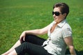 Woman portrait in summer outdoor, sitt on green grass, happy people, city park Royalty Free Stock Photo