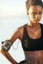 Woman, portrait and sweat for fitness in outdoor with earphones for training, health and music with app for workout Royalty Free Stock Photo