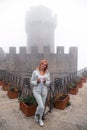Woman portrait. wearing jeans jacket. Fortification on top of the mountain, old castle on background. Journey. Mystical atmosphere