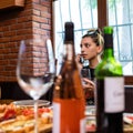 Woman portrait through wine bottles