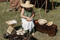 Living history in Roman ancient times woman, cooks food outside