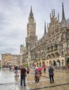 Asian Woman Traveler Poses for her picture in front of the Rathaus in Munich Germany