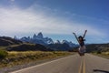 A woman poses on the highway leading to the town of El Chalten and Mt. Fitz Roy