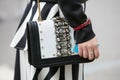 Woman poses for photographers with black and white jewel bag before Etro and Iceberg fashion show, Milan Royalty Free Stock Photo