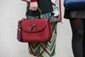 Woman poses for photographers with red Gucci bag with bamboo handle before Etro and Iceberg fashion show,