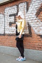 Woman poses for photographers with Stefania Marra golden jacket before Fendi fashion show, Milan Fashion Week