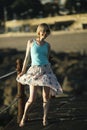 A woman poses on the seafront in summer during sunset. Royalty Free Stock Photo