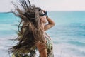 Woman posing on a beach with her hair blowing in the wind Royalty Free Stock Photo