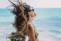 Woman posing on a beach with her hair blowing in the wind Royalty Free Stock Photo