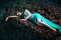 Woman posing on a beach with rocks Royalty Free Stock Photo