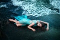 Woman posing on a beach with rocks Royalty Free Stock Photo