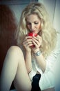 Woman posing with a big red cup of tea in her hands Royalty Free Stock Photo