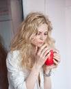 Woman posing with a big red cup of tea in her hands Royalty Free Stock Photo