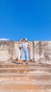 A woman posing in front of an historial old building