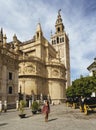 Woman posing with the Giralda and the Cathedral of Saint Mary, Seville, Spain Royalty Free Stock Photo