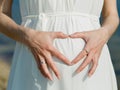 Woman posing heart on her belly Royalty Free Stock Photo