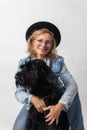 Woman is posing with her Big Schnauzer Dog