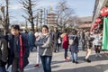 An woman is posing in the middle of crowded Japanese people at the Asakusa entrance Tokyo, Japan February 7, 2020