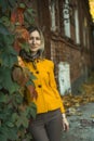 A woman is posing near ancient buildings in autumn. Royalty Free Stock Photo