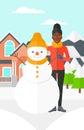 Woman posing near snowman.