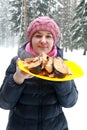 Woman posing with plate of grilled Coho Salmon Fillets
