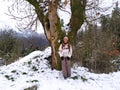 A woman posing in the snow in the bush with trees in the background Royalty Free Stock Photo