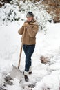 Woman posing with snow shovel