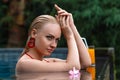 Woman posing in the tropical swimming pool