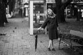 A woman posing with an umbrella. Black and white photo.