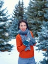 Woman is posing in winter forest, beautiful landscape with snowy fir trees. Dressed in red sweater Royalty Free Stock Photo