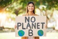 Woman, poster and climate change sign at park for earth, environment and green or eco friendly protest. Young person in Royalty Free Stock Photo
